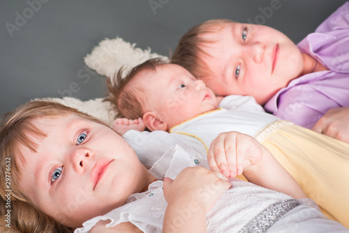 Portrait of three children on a gray background