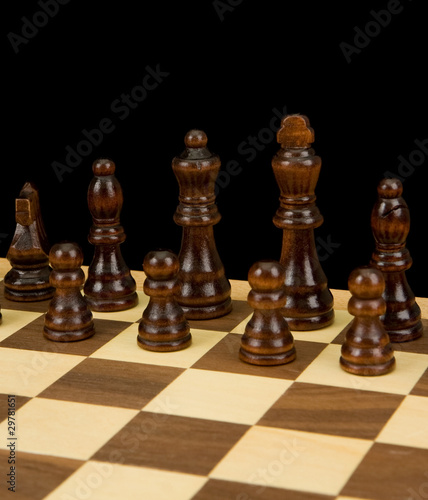chess piece on board isolated on black