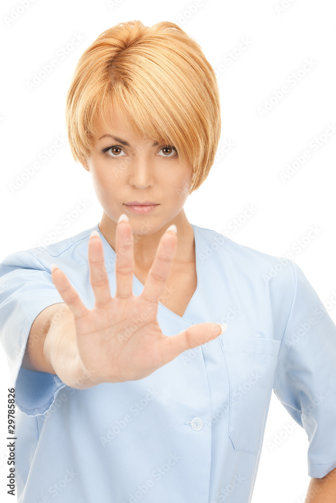attractive female doctor showing stop gesture attractive female doctor showing stop gesture
