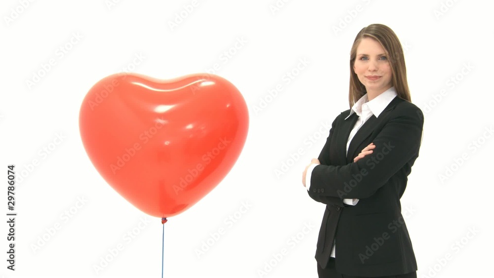Woman standing next to heart balloon Woman standing next to heart balloon