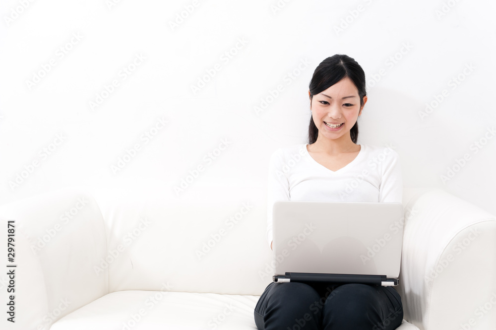 beautiful asian woman using laptop on the sofa beautiful asian woman using laptop on the sofa