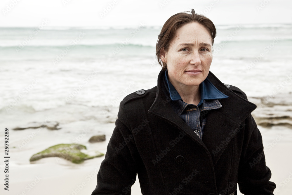 Attractive woman at beach with thoughtful expression. Attractive woman at beach with thoughtful expression.