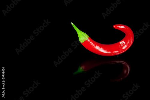 Red hot chili pepper on black background with reflection photo