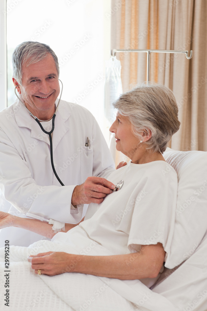 Senior doctor taking the heartbeat of his patient Senior doctor taking the heartbeat of his patient