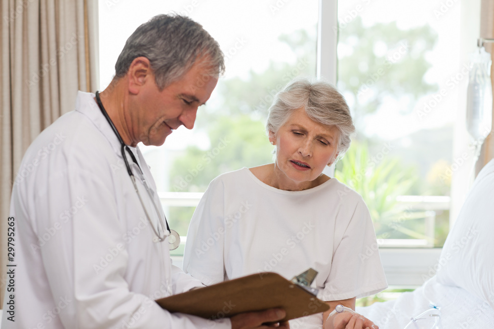 Mature doctor with his patient Mature doctor with his patient