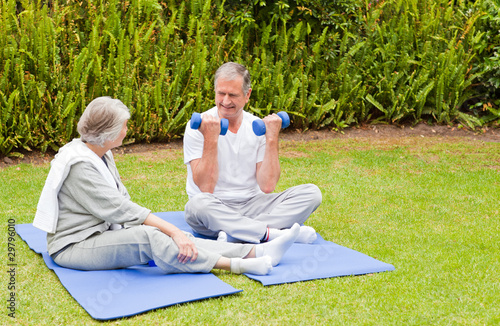 Mature couple doing their exercises in the garden