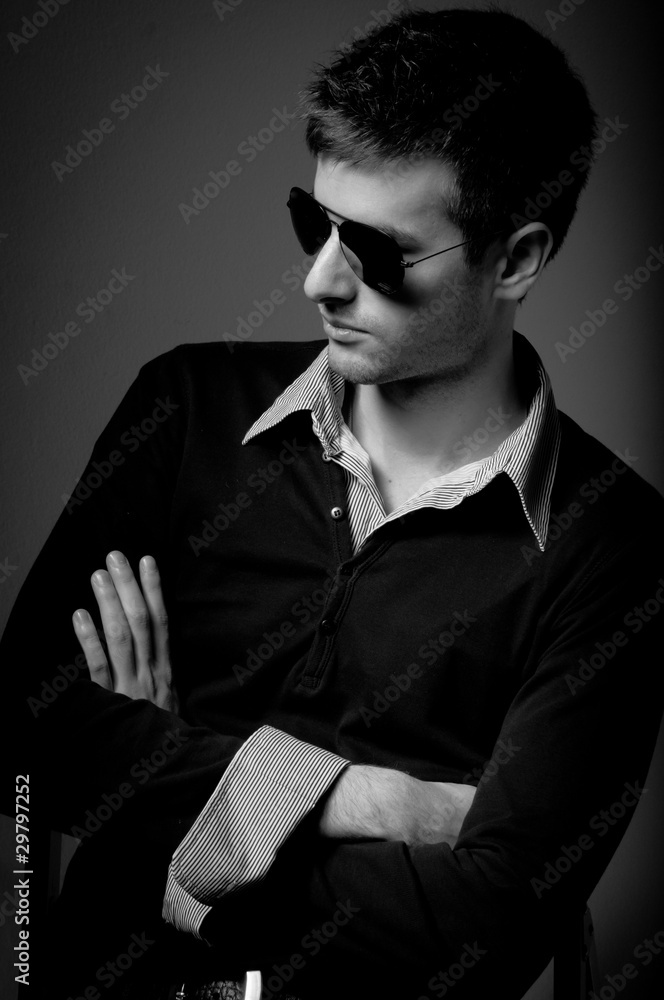 Portrait of a young man wearing sunglasses in black and white Portrait of a young man wearing sunglasses in black and white