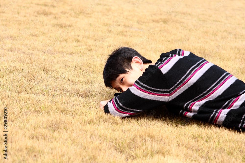 Young man lying on grass