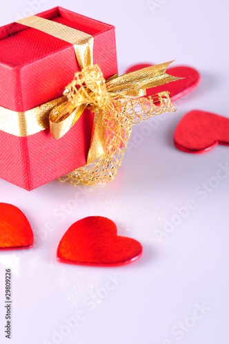red gift box and hearts on white