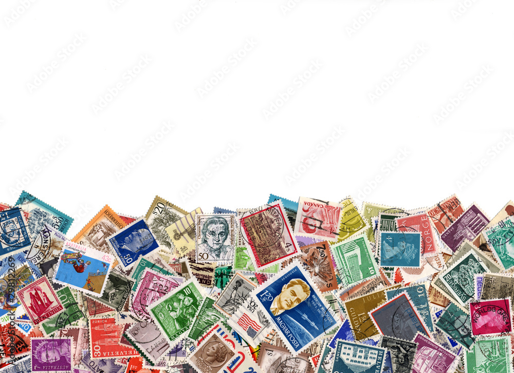 Large amount of postage stamps isolated on white
