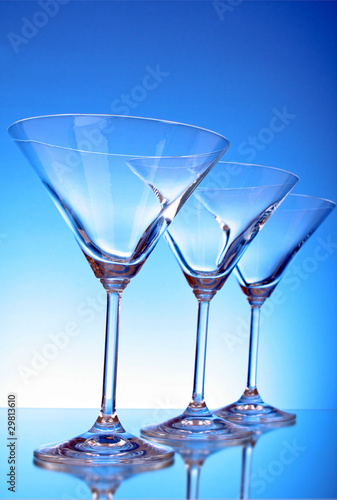 empty glasses of martini on the light blue background