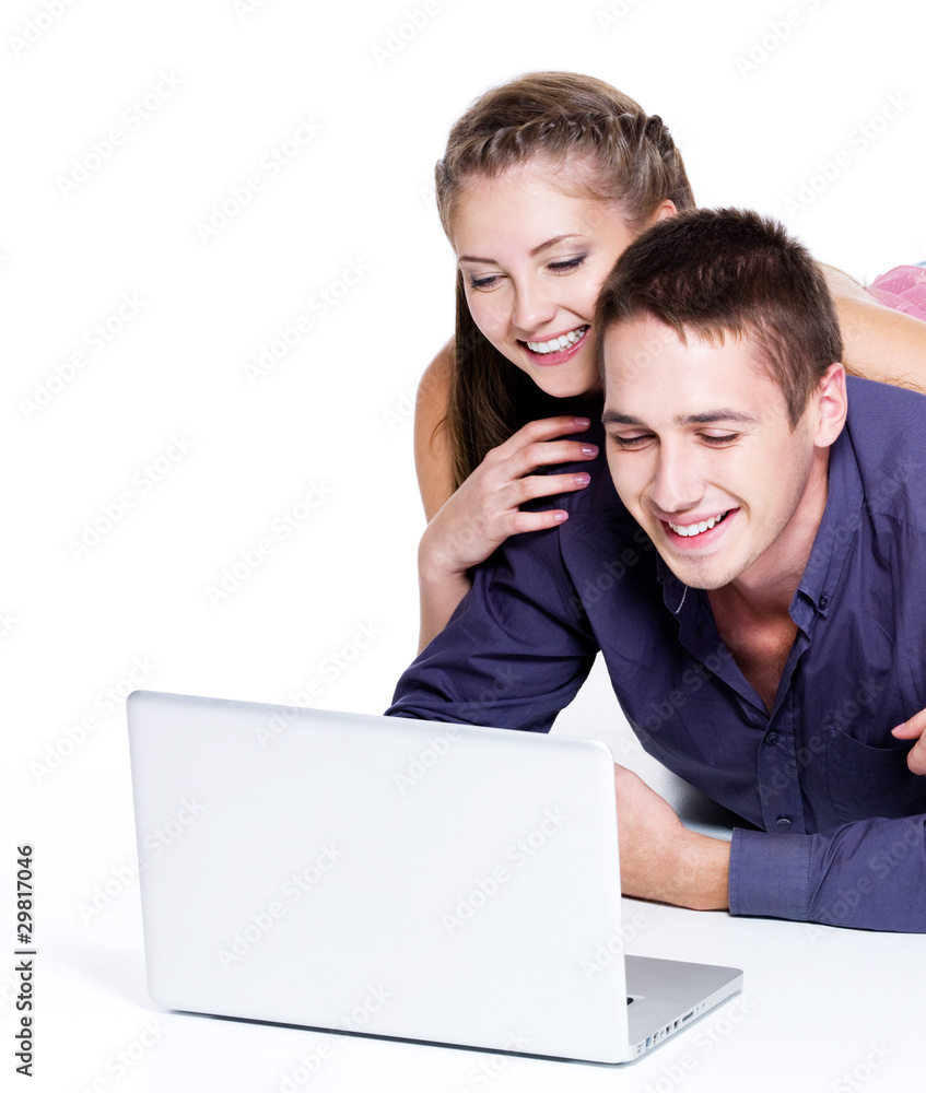 Happy smiling couple looking at laptop Happy smiling couple looking at laptop