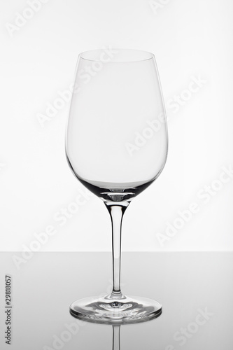 empty wine glass with reflection on white