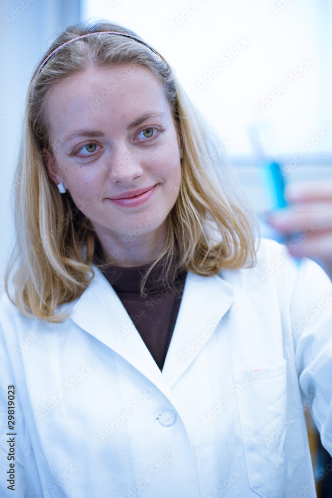 Closeup portrait of a female researcher carrying out experiments Closeup portrait of a female researcher carrying out experiments