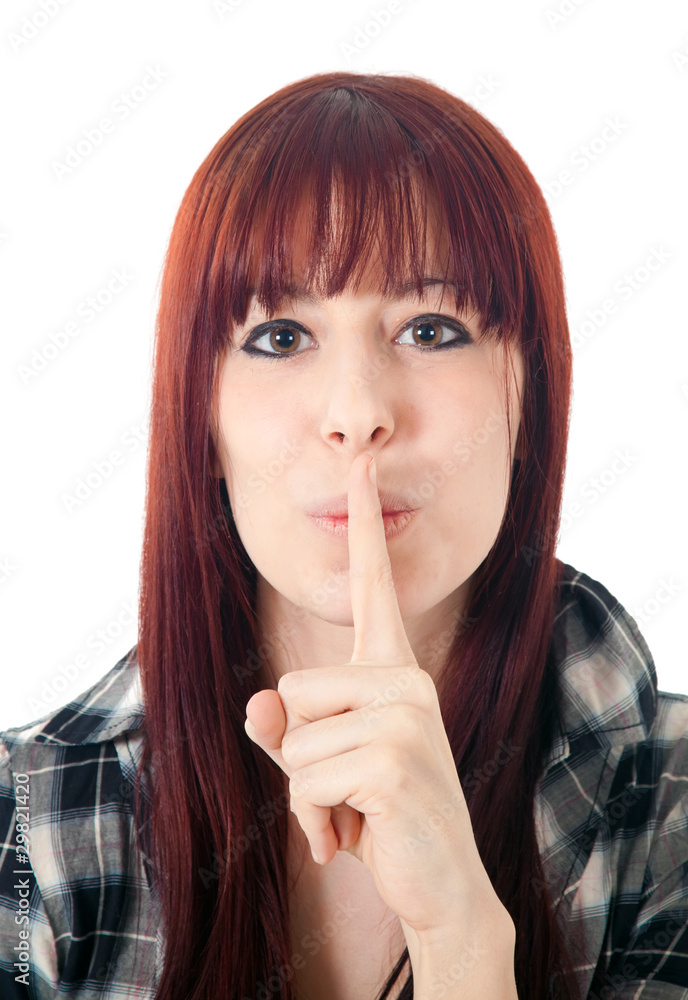 Woman standing with finger over her mouth isolated on white