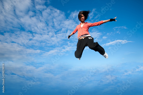sport woman jumping and fly over sky
