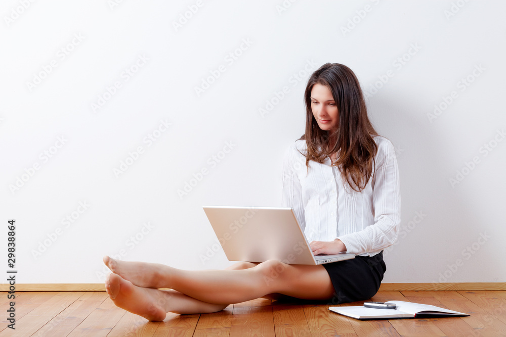 Young business woman working at home with laptop Young business woman working at home with laptop