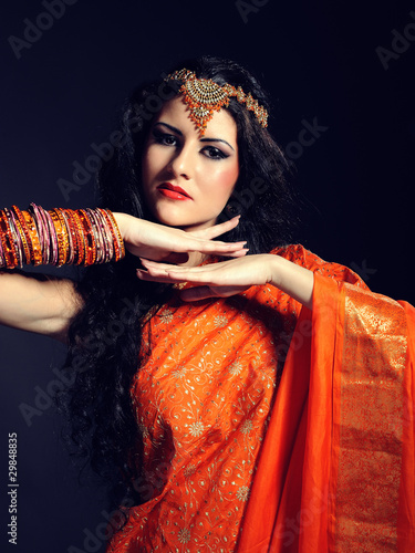 Young beautiful woman in indian traditional sari dress photo