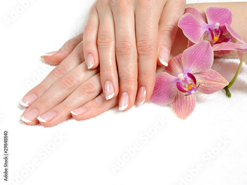 Beautiful hand with perfect nail french manicure and purple orch #29848840