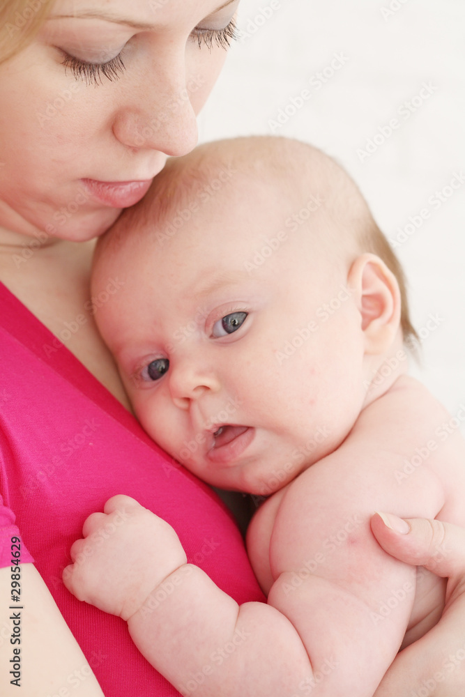 Young mum holds on hands of the chest baby Young mum holds on hands of the chest baby