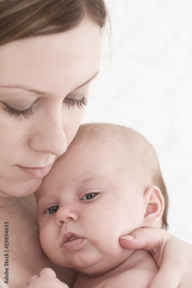 Young mum holds on hands of the chest baby Young mum holds on hands of the chest baby