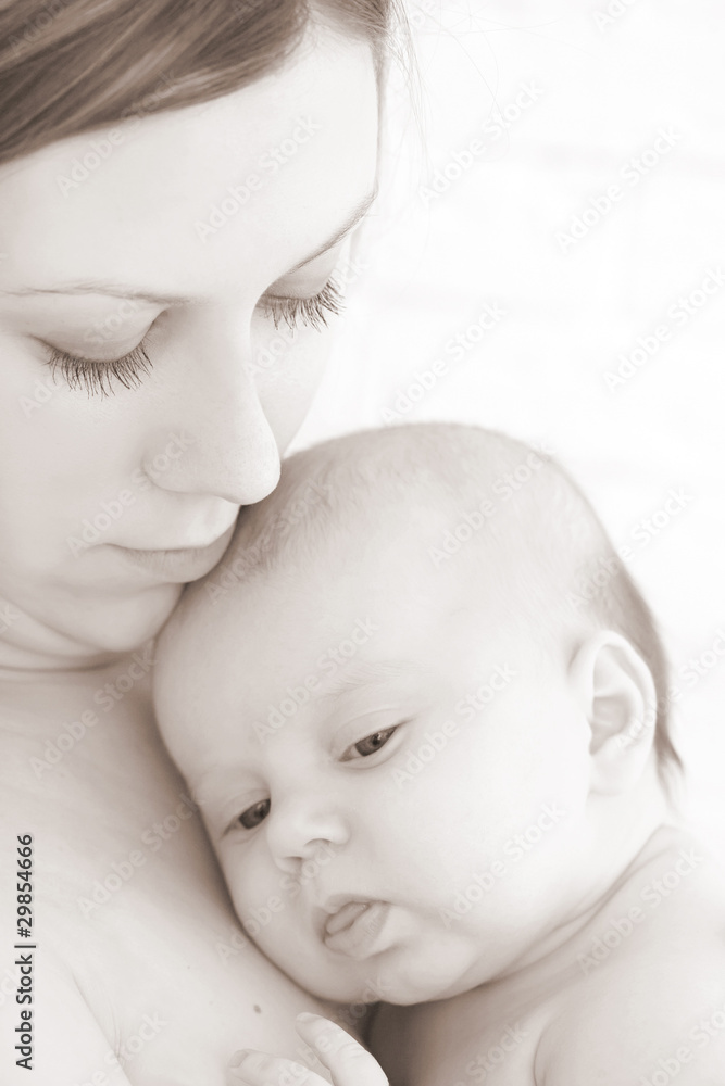 Young mum holds on hands of the chest baby Young mum holds on hands of the chest baby