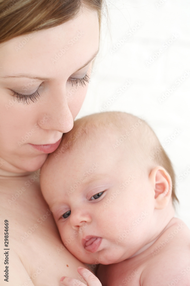 Young mum holds on hands of the chest baby Young mum holds on hands of the chest baby