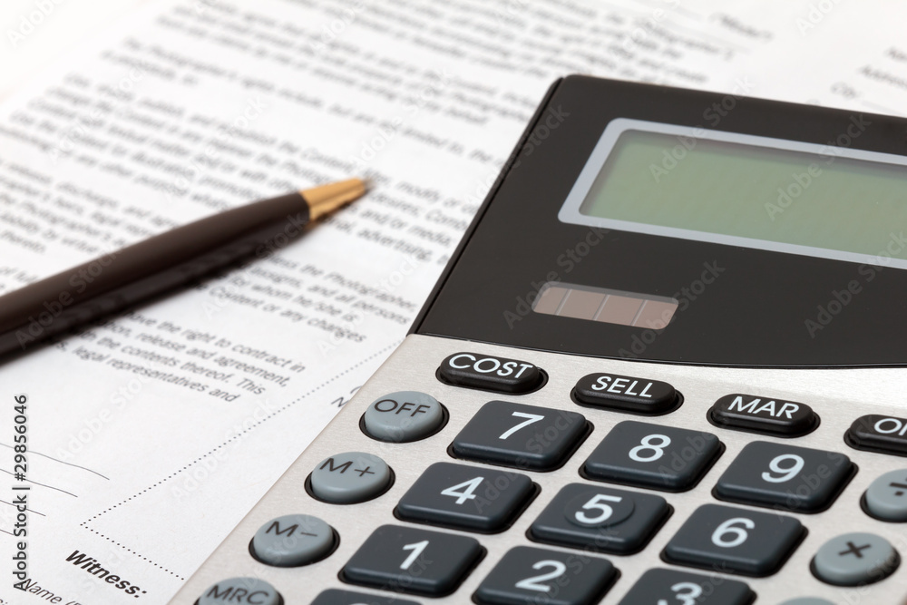 Calculator, pen and contract - business situation Calculator, pen and contract - business situation