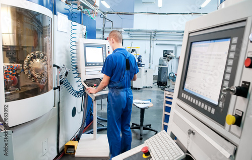 worker operating CNC machine center