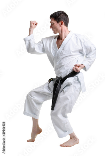 Karate. Man in a kimono with a white background