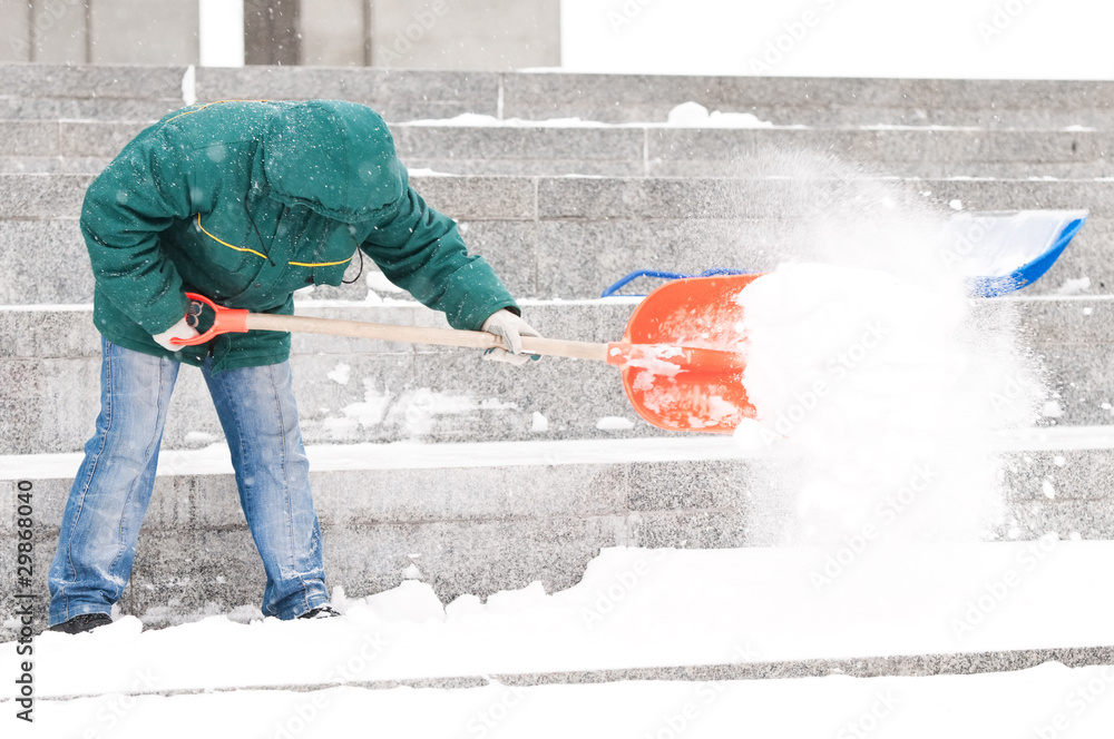 Fototapeta premium Man shoveling winter snow