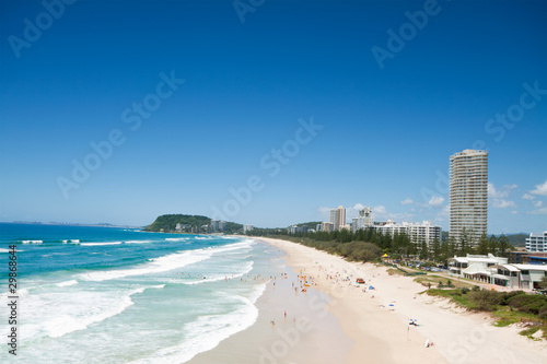 australian beach during the day with buildings beside © p a w e l