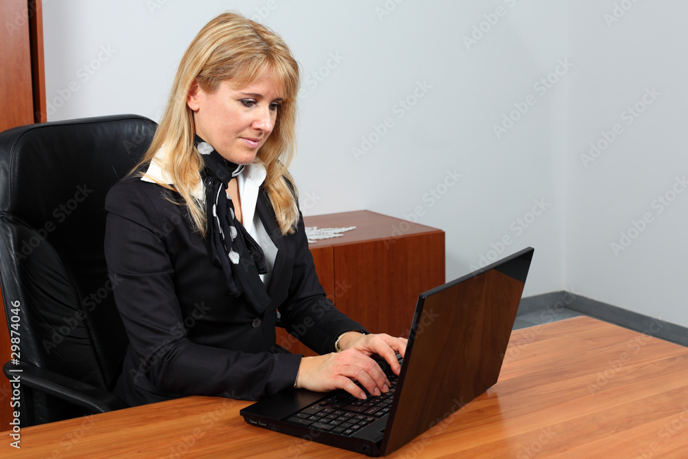 Attractive secretary is typing and sending e-mail. Attractive secretary is typing and sending e-mail.