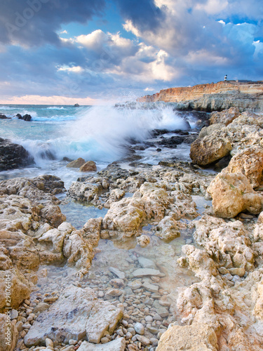 Seashore with stone during bright sundown