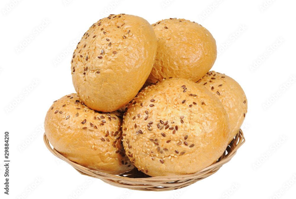 Bun, topped with sesame seeds in a basket