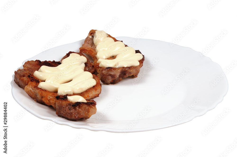 Grilled meat with mayonnaise on a plate. Grilled meat with mayonnaise on a plate.