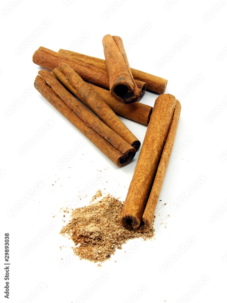 Cinnamon sticks whole & grated on a white background Cinnamon sticks whole & grated on a white background