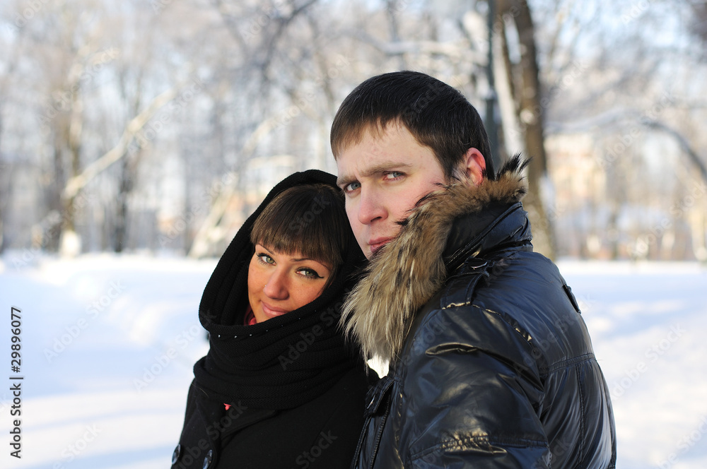 Young couple on a walk in the park in winter Young couple on a walk in the park in winter
