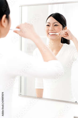 beautiful asian woman blushing her teeth