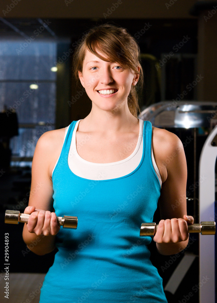 beautiful woman is exercising in gym at evening beautiful woman is exercising in gym at evening