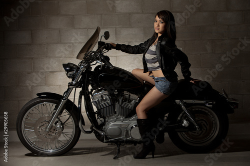 Sexy attractive twenties asian woman sitting on motorcycle