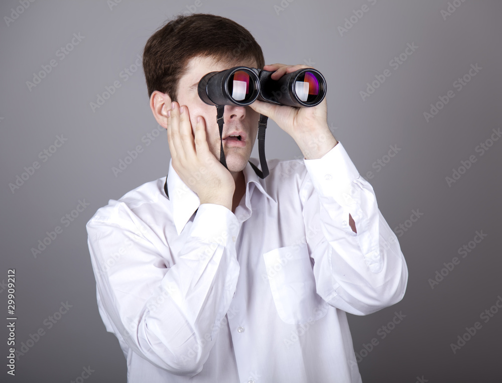 Young businessmen in t-shirt with black binocular