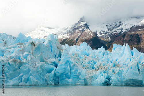 Blue icebergs and snowy mountains at Grey Glacier in Torres del