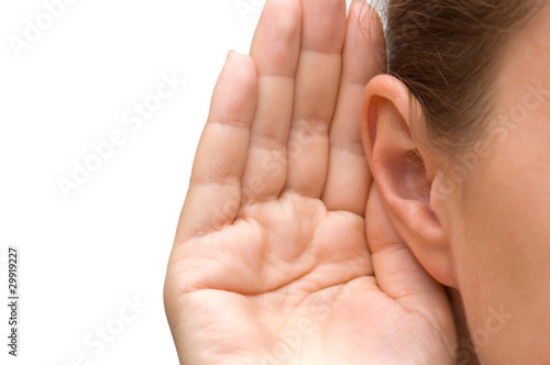 Fototapeta Girl listening with her hand on an ear