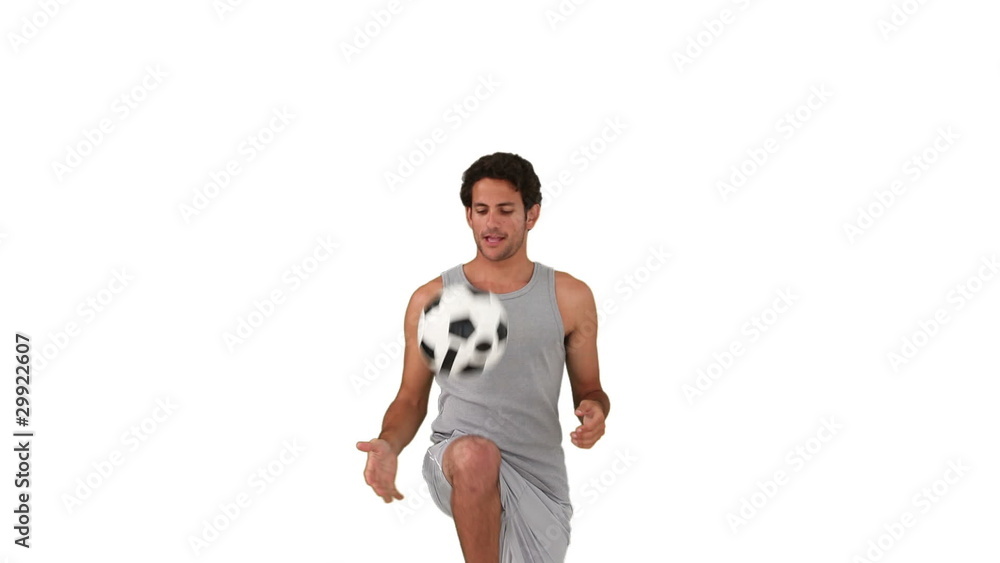 Dark-haired man in sportswear playing with a soccer ball Dark-haired man in sportswear playing with a soccer ball