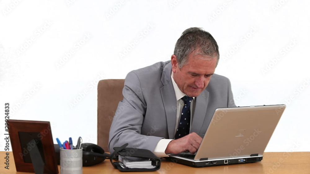 Elderly businessman working on his laptop