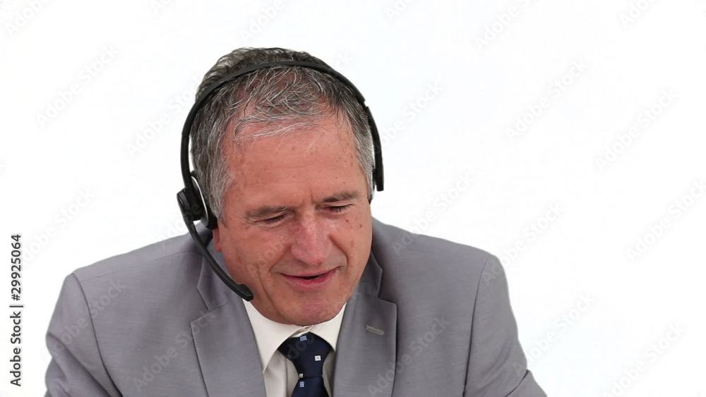 Elderly man in a call center having a phone call Elderly man in a call center having a phone call