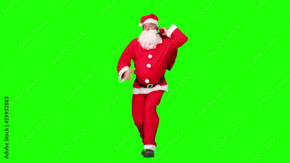 Santa Claus holding a bag of gift and dancing Santa Claus holding a bag of gift and dancing