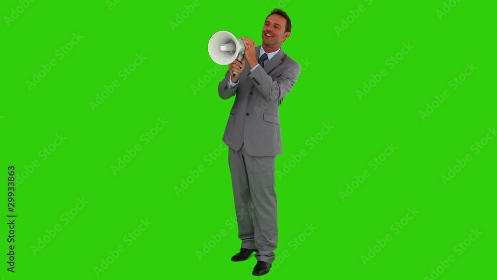 Man in a gray suit shouting through a megaphone Man in a gray suit shouting through a megaphone