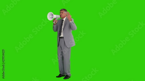 Mature businessman giving orders with a megaphone photo